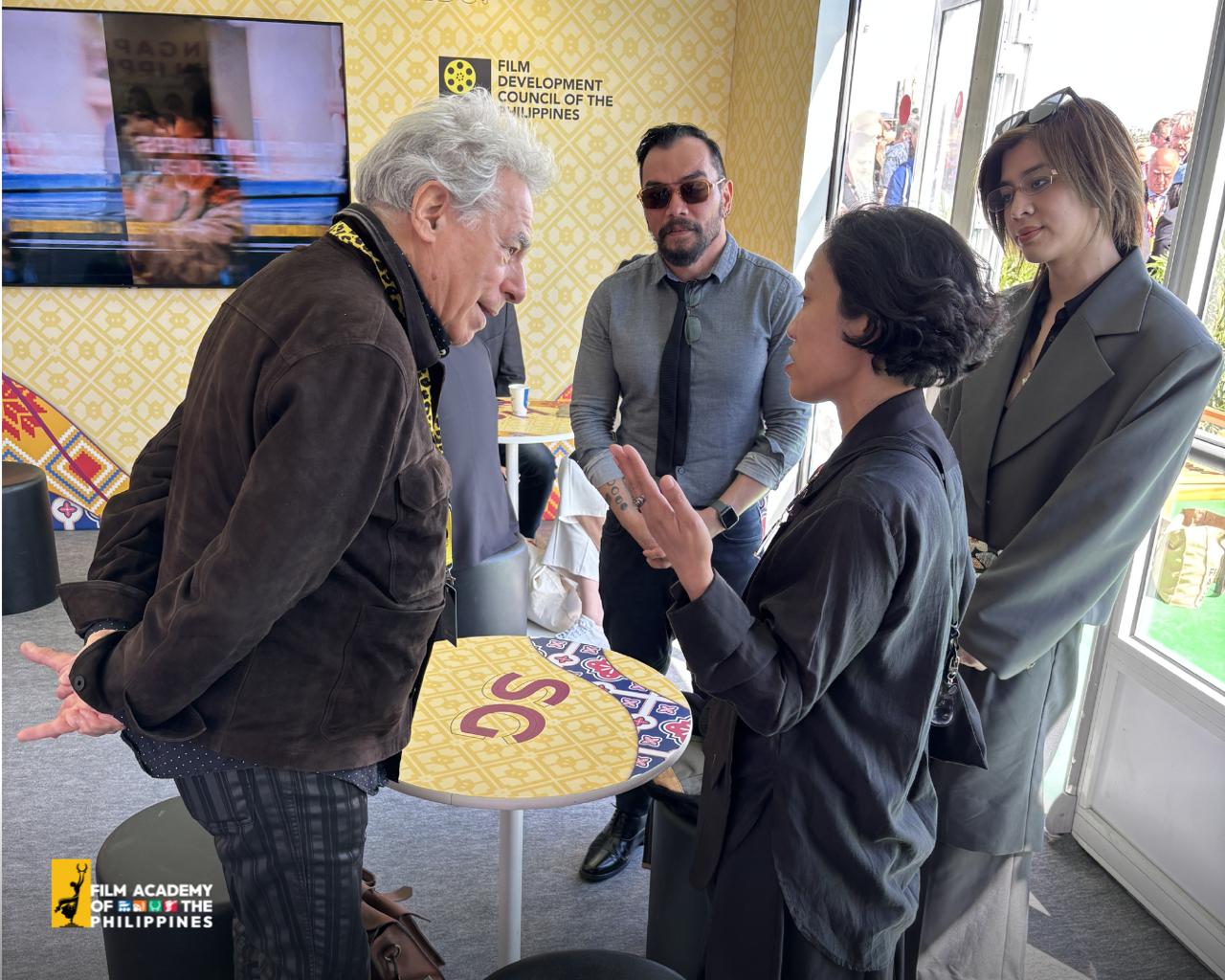 Director-General Paolo Villaluna and Kristine Kintana in discussion at the Singapore-Philippines Pavilion during Cannes 2026.