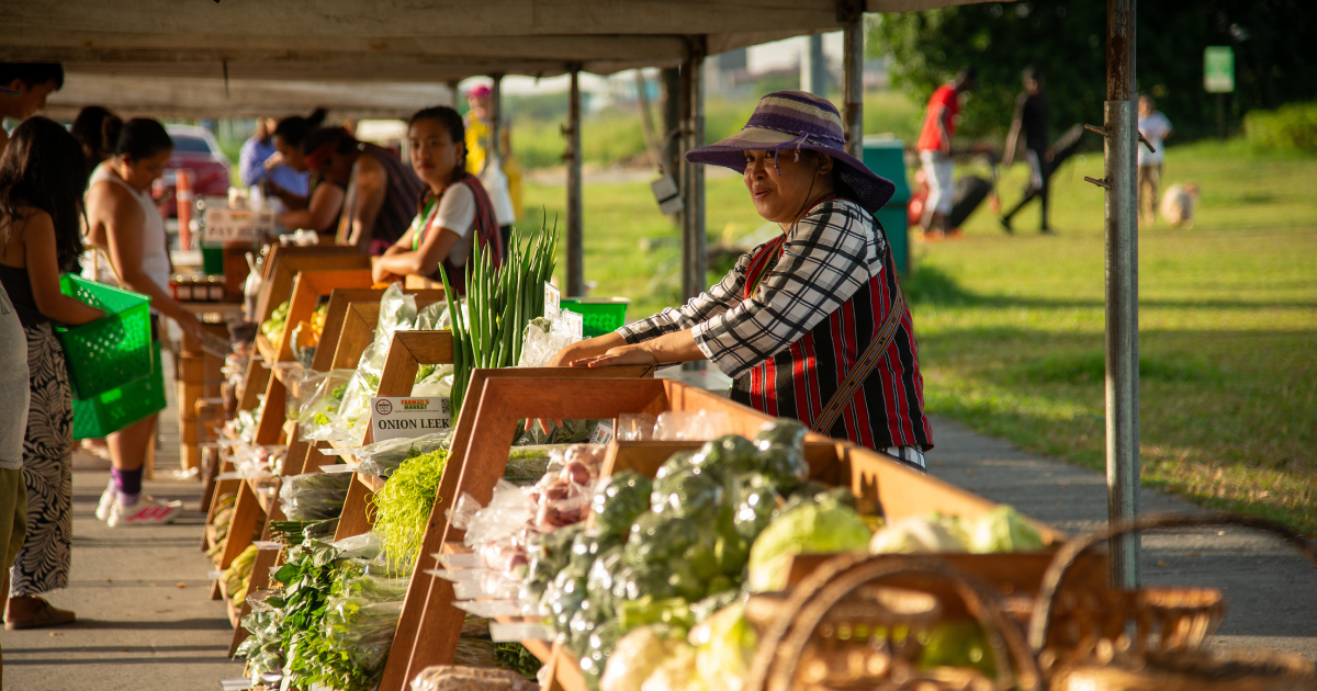 A Benguet farmer arranges vegetable produce for sale at the DMCI Homes Weekend Market
